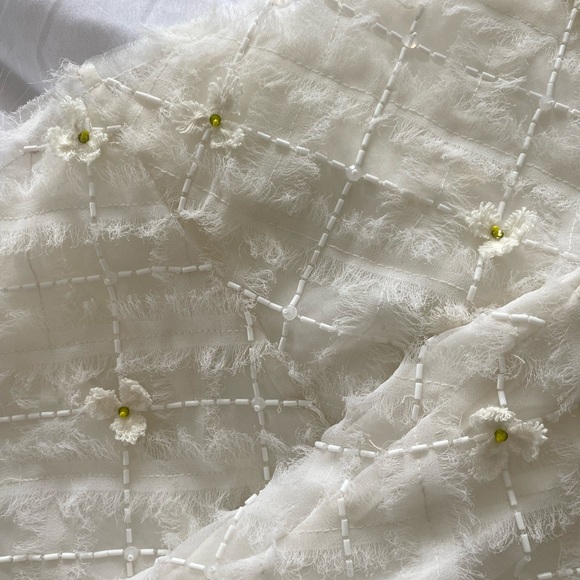 Stunning ivory white open cutting out with delicate flowers cute detailing. - Picture 5 of 16